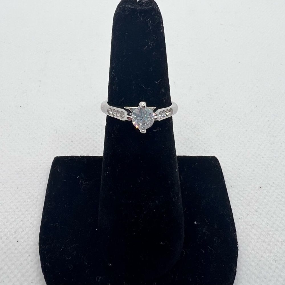 Circle cut faux diamond engagement ring on a silver tone band - size 6.5